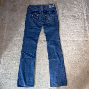 True Religion mid-rise skinny jeans, horseshoe bedazzled pockets.